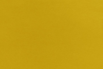 Close-up texture of yellow crepe corrugated blotting paper for DIY. Concept of choice. Soft focus, high contrast, horizontal background shot