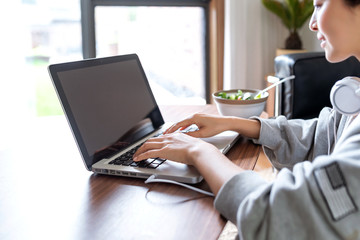 A young Asian woman in a sports office at home