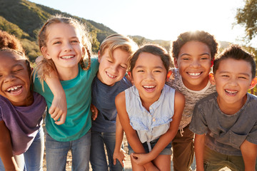 Portrait Of Multi-Cultural Children Hanging Out With Friends In Countryside Together - Powered by Adobe