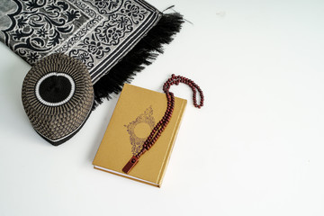 Islamic Holy Book Quran with prayer beads on White Background. Ramadan concept