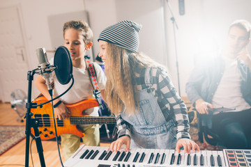 Fototapeta na wymiar kids rock band practice in music studio
