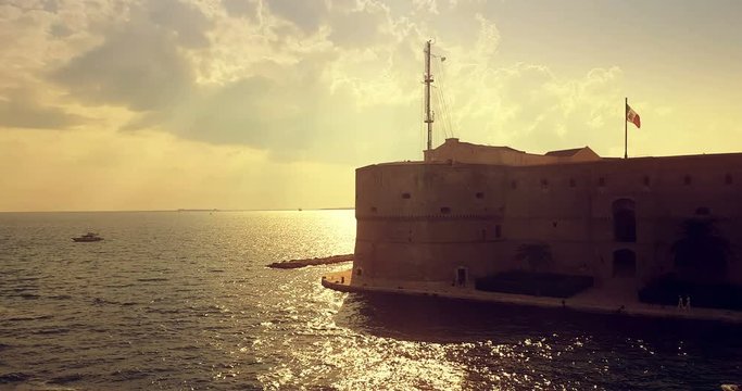 landscape of taranto port in italy with calm sea on sunset