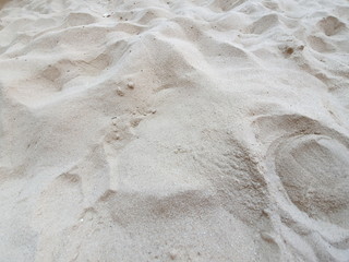 A close up shot of an uneven dry sand in a sandy beach
