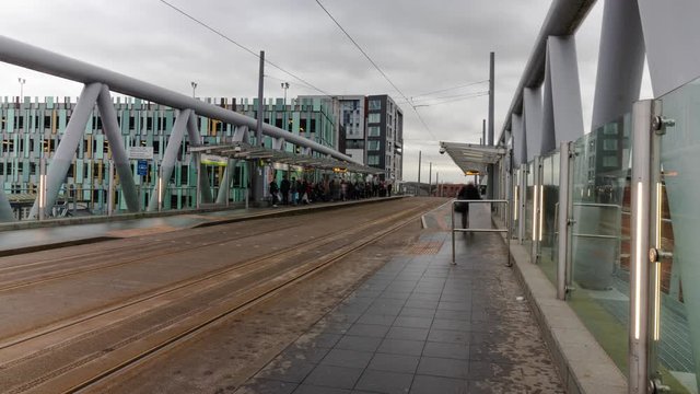 Nottingham, England: NET Tram Timelapse at Station stop of busy commuters