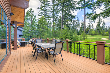 Beautiful large cabin home  with large wooden deck and chairs with table overlooking golf course. - 342308800