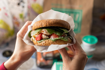 Burger with salmon, tomatoes and lettuce