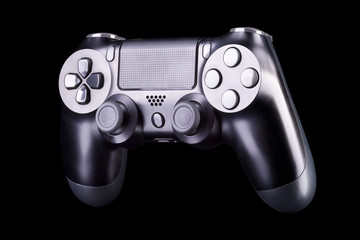 Black video game joystick gamepad isolated on a black background