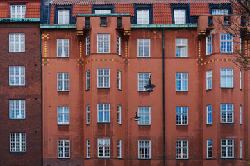 facade of a multi-storey building with people in the Windows