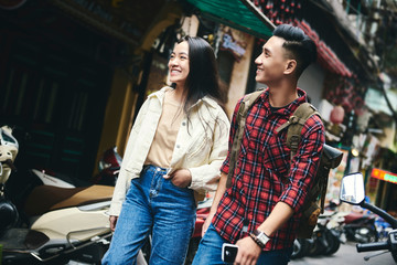 Fototapeta na wymiar Young Asian couple exploring the city