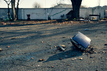 Old CRT (Cathode ray tube) television on a asphalt floor in an abandoned area. Environmental...