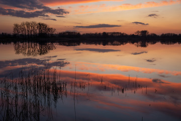 Clouds after sunset reflecting in the surface of the lake