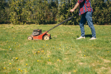 man using lawn mower outdoor