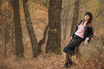 Naklejka na ściany i meble Beautiful brunette girl in nature, autumn forest