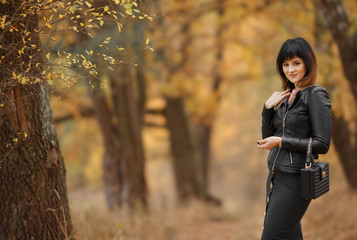 Beautiful brunette girl in nature, autumn forest