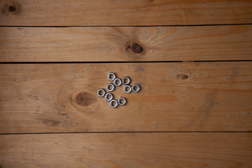 screws  placed on a wooden table