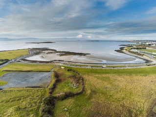 Aerial view on Ballyloughane Beach, Galway city. Warm cloudy day. Hare Island.