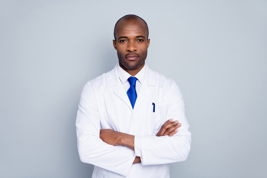 Photo of serious doctor dark skin guy virologist biohazard agent corona virus conference arms crossed insist urgent quarantine wear white lab coat tie isolated grey color background