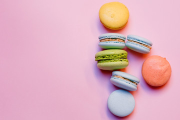 Colorful macaroni cookies, macaroni cake or macaroni cookies on a pink background. Space for text