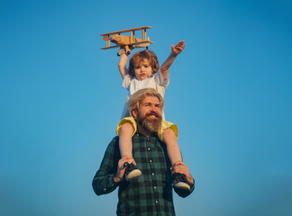 Fathers day. Father and son. Father giving son ride on back. Portrait of happy father giving son...