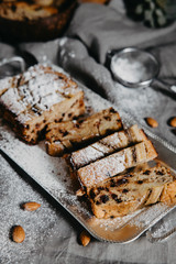 Butter-free, sugar-free banana bread with oat flour, soft curd cheese and honey. Top view of sliced banana bread on gray marble background. Ideas and recipes for healthy diet breakfast