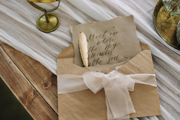 romantic love letter. Old letter with vintage handwriting, envelope and feather pen on the table....