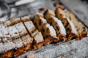 Butter-free, sugar-free banana bread with oat flour, soft curd cheese and honey. Top view of sliced banana bread on gray marble background. Ideas and recipes for healthy diet breakfast