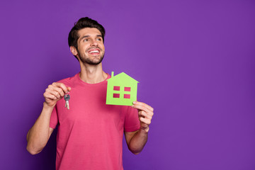 New flat easy mortgage offer move concept, Positive guy hold paper card house keys think thoughts imagine his home look copyspace wear pink outfit isolated bright shine violet color background