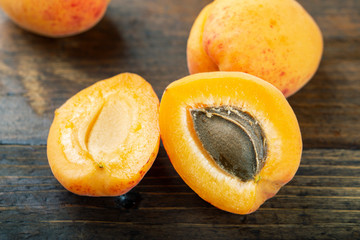 Ripe apricots on the wooden background.