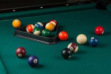 Billiards balls and cue on billiards table. Billiard sport concept