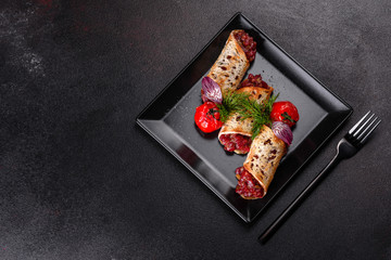 Delicious fresh beef tartar with toasts on a black square plate