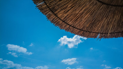 Beach umbrella with a blue sky in the background © Marko Tomic