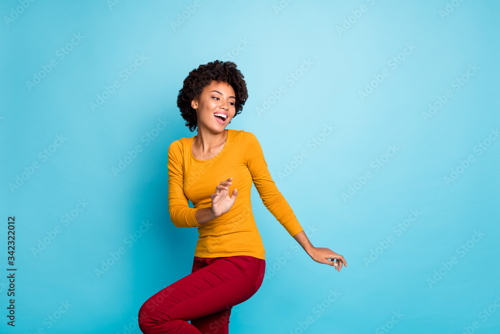 Poster Portrait of wild crazy millennial afro american clubber girl dance in discotheque feel enjoy rejoice wear red pants trousers isolated over blue color background