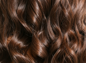 Healthy curly female hair, closeup