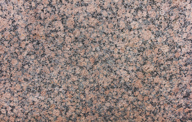 Granite rock texture background close up view. Grey black and pale pink mineral stone marbel surface. Natural granite material stone background with empty copy space. Abstract empty seamless backdrop