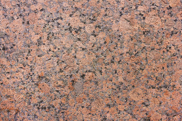 Granite stone wall texture pattern of natural mineral rock background. Granite massive hard rock structure background. Empty rough stone material, dark red granite surface 