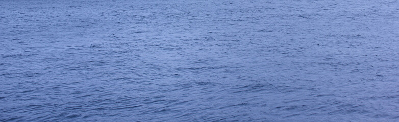 Water blue texture background. Calm deep river water surface, regular water with small ripples texture. Bluish aqua concept backdrop, plain background