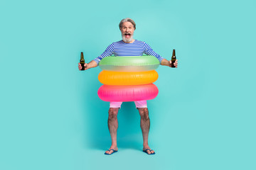 Full body photo of funny aged man traveler stand inside three colorful circles lifebuoy hold two...