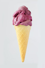 Pink ice cream in a waffle cone