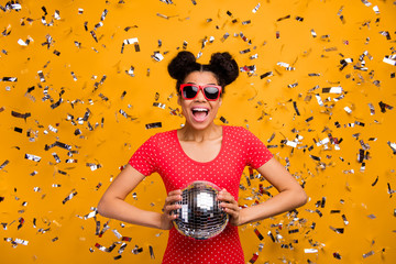 Portrait of excited positive afro american girl student hold glitter ball enjoy nightlife party...