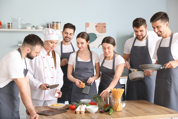 Female chef and group of young people during cooking classes