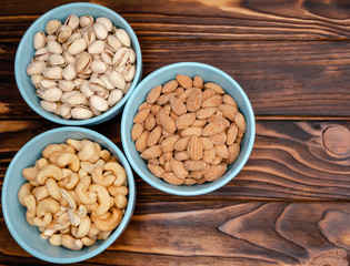 Hazelnuts in wooden bowl. Food mix background. Assortment of nuts