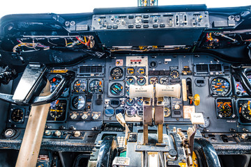 Old aircraft cockpit closeup with many gauges and yoke