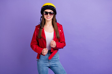 Portrait of charming cool girl biker ready ride her moped scooter travel long distance wear yellow protective helmet clothes isolated over purple color background