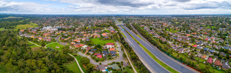 Eastlink highway passing through residential areas in Melbourne, Australia - aerial panorama