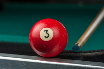 Billiards balls and cue on billiards table. Billiard sport concept