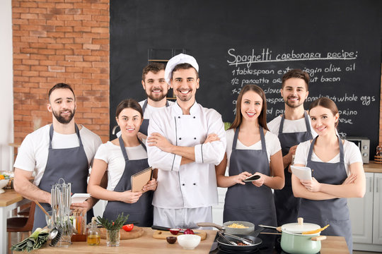 Male chef and group of young people during cooking classes