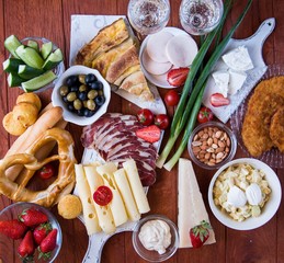 Traditional Serbian and Balkan food Dried meat fried meat 3 types of cheese Balkan cheese pie served with Serbian salad, bread, tomato, onions and olives Rustic Natural.Wooden background. Close-u