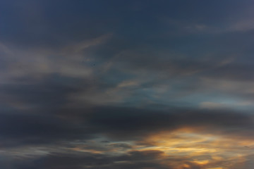Obraz premium The sky at sunset. Cumulus clouds lit by the rays of the setting sun.