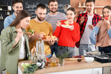 Young friends cooking together at home