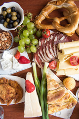 Traditional Serbian and Balkan food. Dried meat,  fried meat. 3 types of cheese. Balkan cheese pie served with Serbian salad, bread, tomato, onions and olives Rustic Natural.Wooden background. Close-u